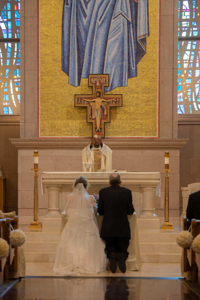 consecration during a wedding mass at St. Joseph Husband of Mary Catholic Church taken by Las Vegas wedding photographer Alexis Dean