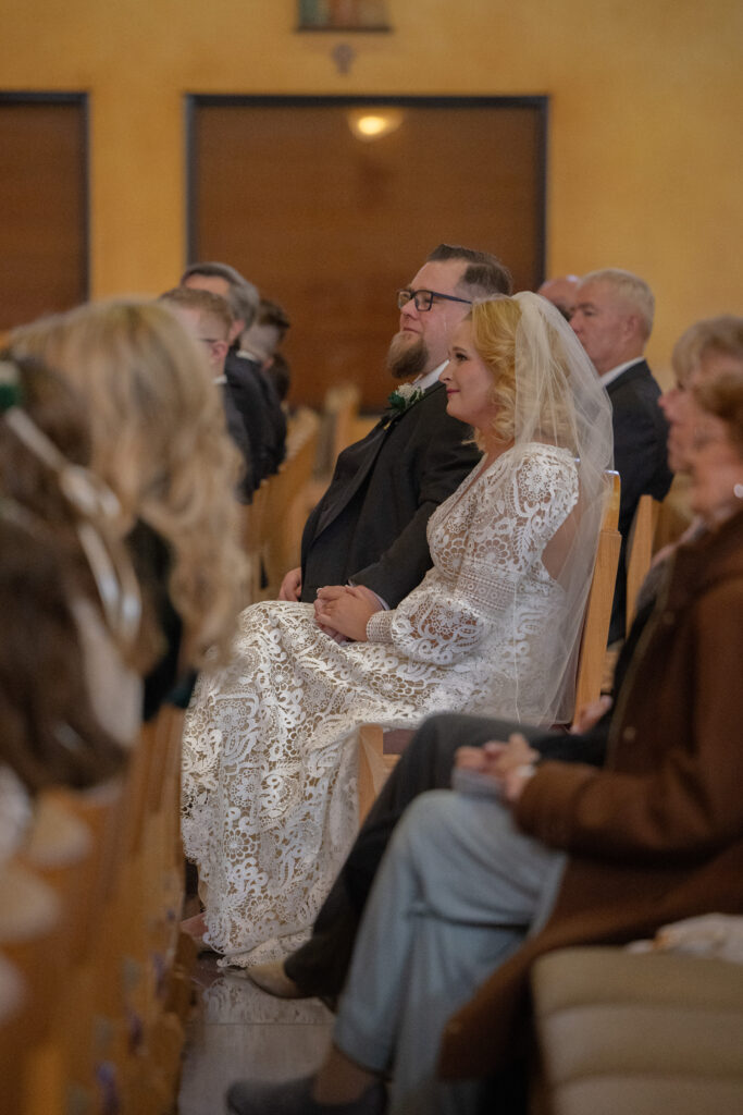 bride and groom listening to the homily during their nuptial mass in Las Vegas, Alexis Dean Las Vegas Catholic Wedding photographer