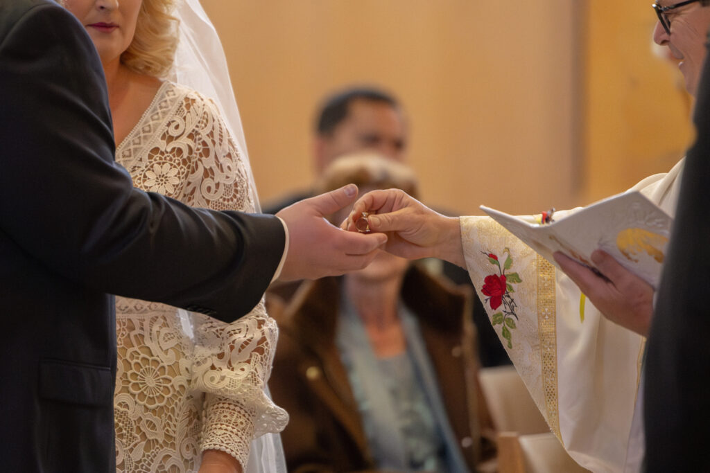 priest handing groom the rings at their Catholic wedding Las Vegas, Alexis Dean Photography