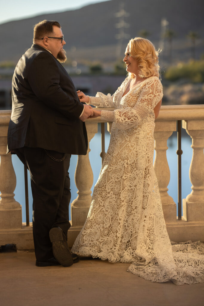 newlyweds sharing their favorite memories in Lake Las Vegas, taken by Catholic wedding Photographer Alexis Dean