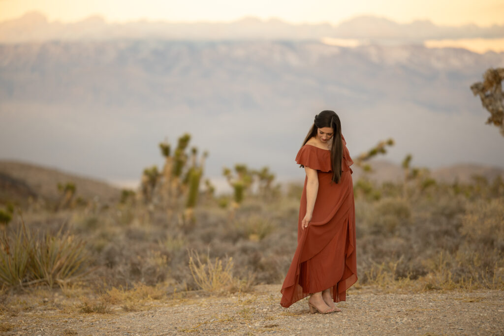 gentle reflection with purple mountains in the background of pregnant mom las vegas joshua trees alexis dean photography