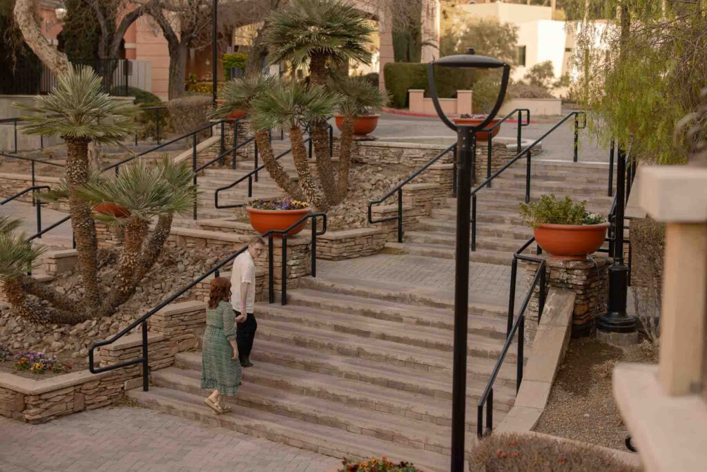 husband leading wife up the stairs at lake las vegas anniversary session alexis dean photography