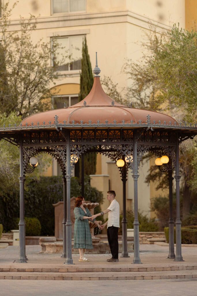 husband and wife dancing under a gazebo in lake las vegas