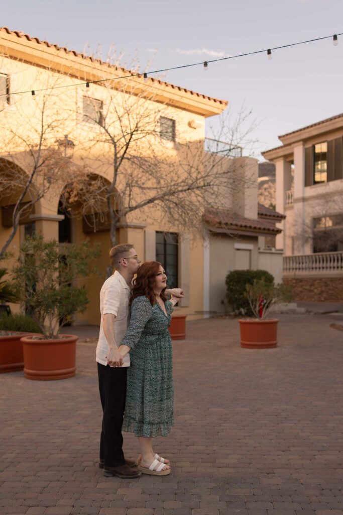 couple playing airplane in a lake las vegas courtyard during their anniversary session with alexis dean photography