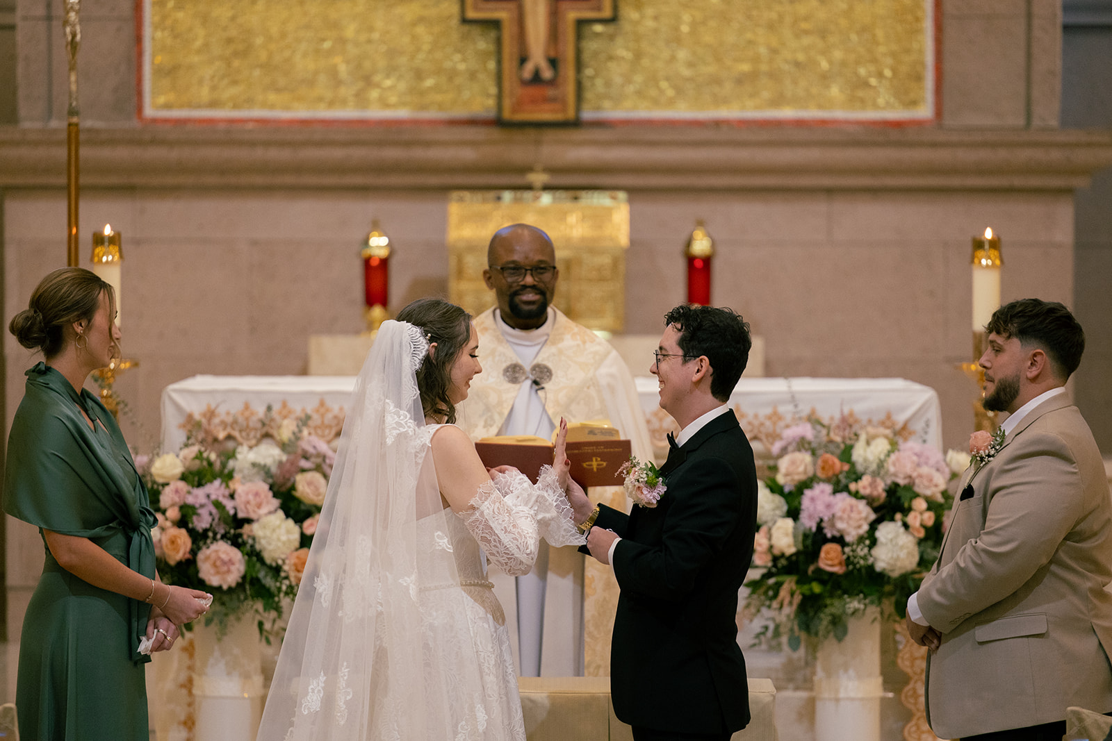 bride and groom exchanging rings at Catholic Church St. Joseph Husband of Mary in Las Vegas, NV