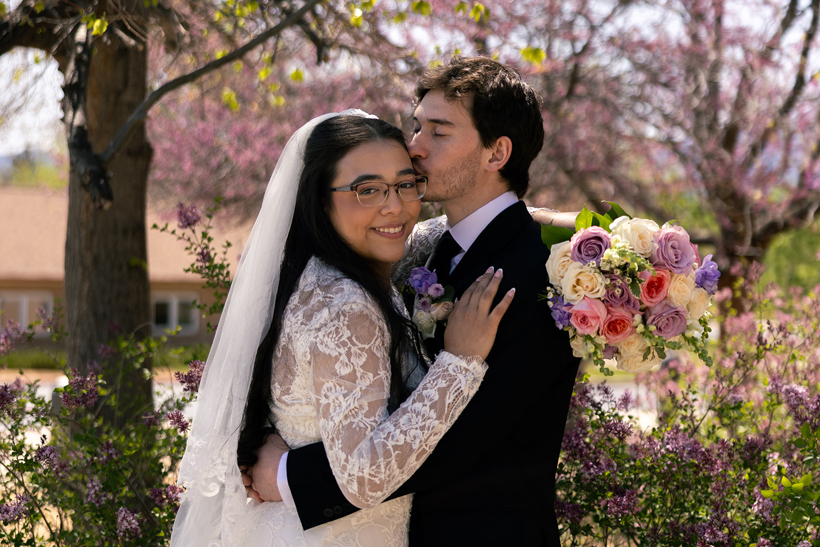 bride and groom outside of Sacred Heart of Mary Catholic Church in Boulder Colorado taken by Alexis Dean Photography